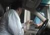 paying toll both guy with pennies