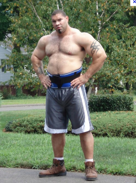 Chubby man posing muscles